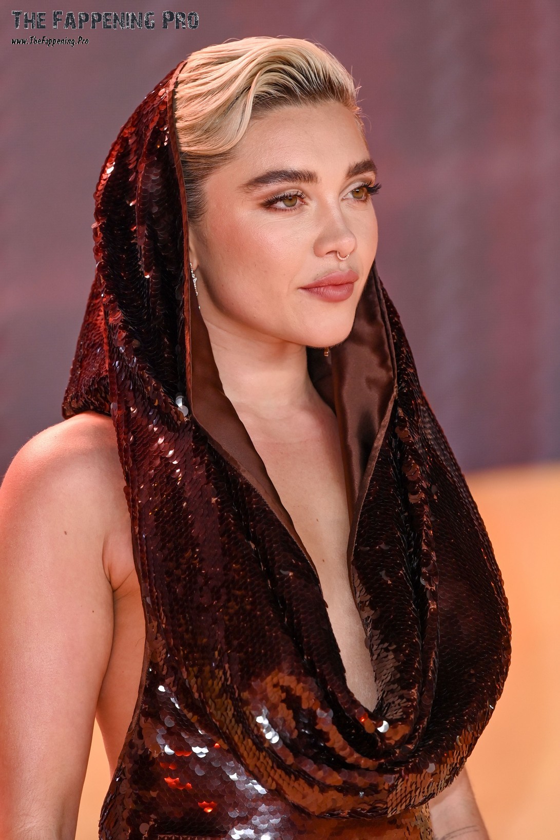 Get ready for some shocking and scandalous news from the world of Hollywood! The talented and beautiful actress Florence Pugh made jaws drop at the premiere of Dune: Part Two by flaunting her assets in a daring outfit. The 28-year-old starlet left little to the imagination in a futuristic dress that showcased her bare back and hood. But what really caught everyone's attention was Florence's bold decision to go topless, revealing her small yet sensational breasts. It seems like this British beauty isn't shy about showing off her body, as she continues to ditch the traditional bra for a more revealing look. If you're a fan of Florence Pugh, you won't want to miss out on this headline-grabbing moment!