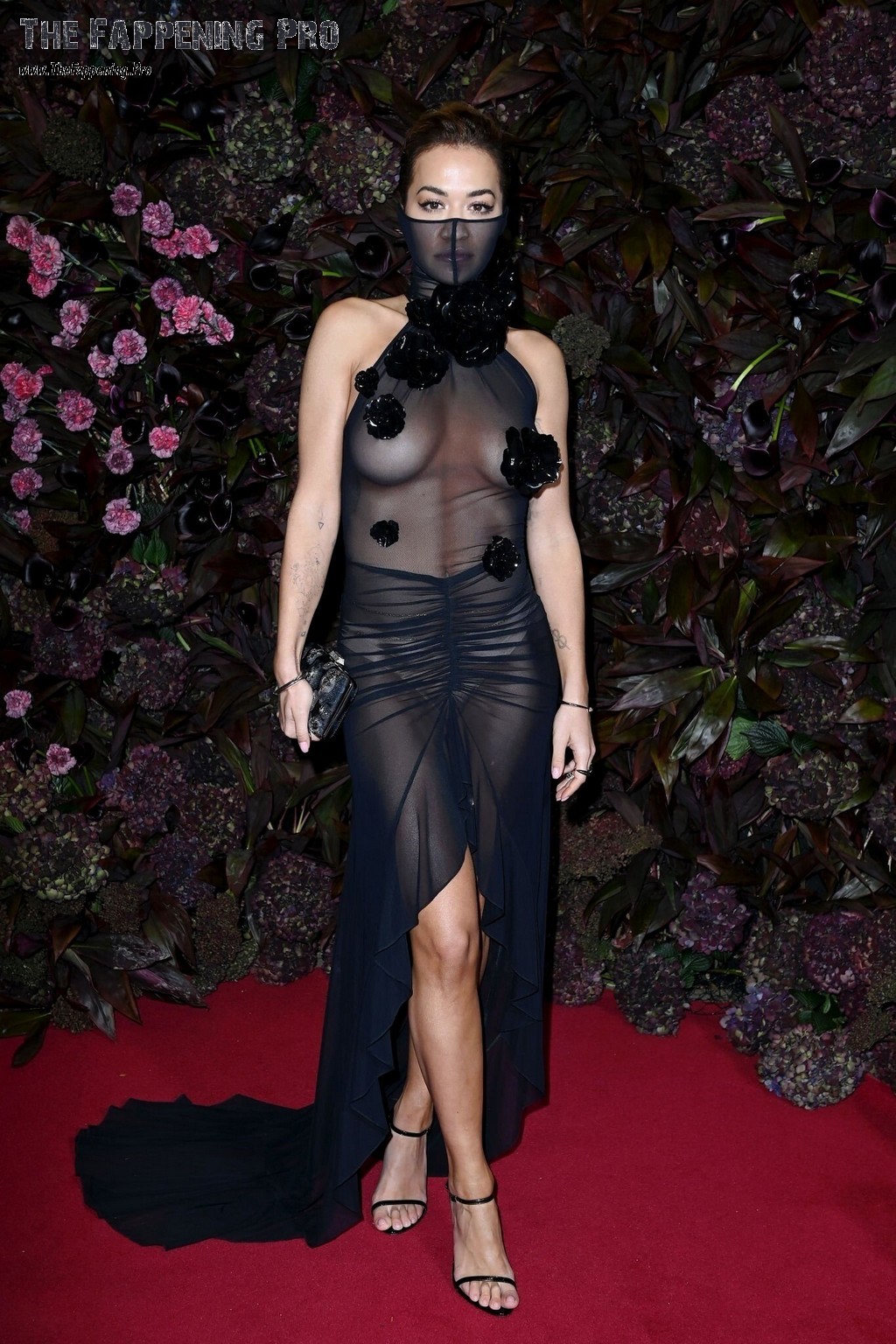 At the British Vogues 2023 Forces For Change Party in London, Rita Ora made a jaw-dropping entrance in a completely see-through dress, leaving nothing to the imagination. Despite the designer's intentions to cover her bare chest with decorative flower buds, her nude tits were on full display. To add to the scandalous look, she also wore tiny white panties that could be seen from afar. The singer certainly turned heads and sparked a frenzy at the event, making a bold statement that won't soon be forgotten.