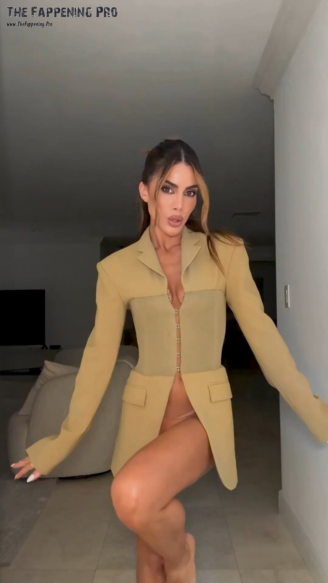 Join Brazilian supermodel Camila Coelho as she turns heads at a concert with her daring outfit choice. With a long jacket worn without a bra and a chain-like skirt, Camila leaves little to the imagination in her provocative ensemble. See her jaw-dropping look and behind-the-scenes fitting video on her latest adventure!