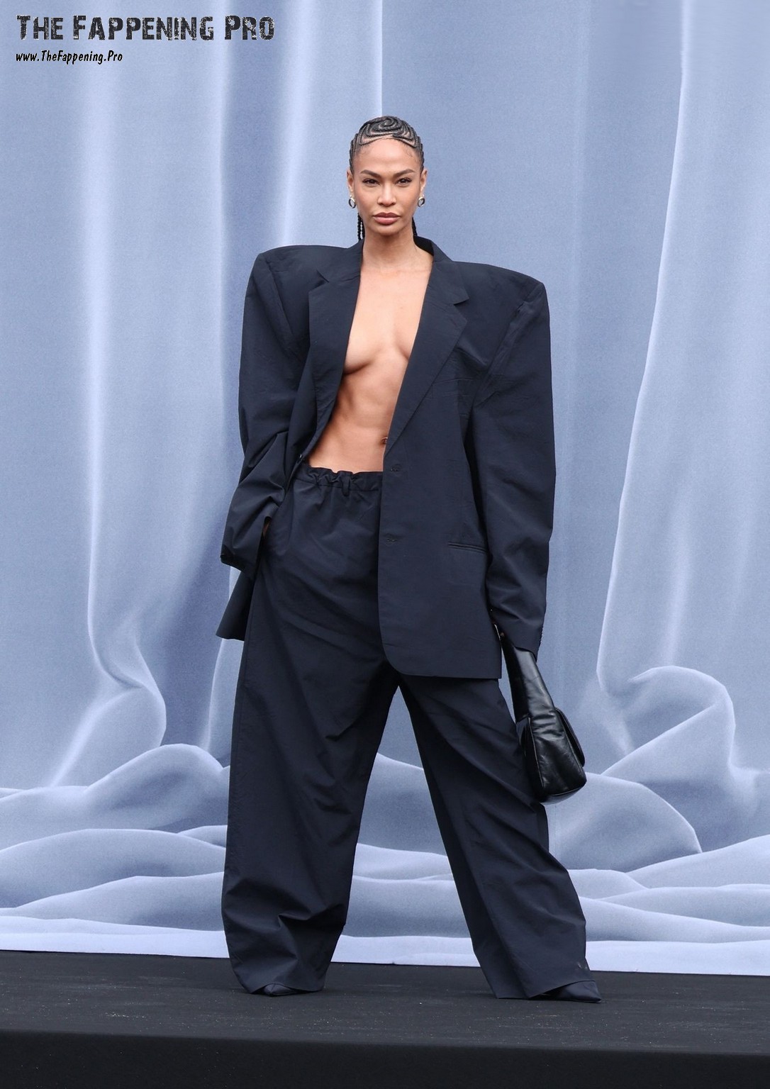 Experience the jaw-dropping moment at the Balenciaga Fashion Show for Paris Fashion Week 2024, where the stunning 35-year-old model Joan Smalls caused a sensation by baring it all on stage! Unlike the usual wardrobe malfunctions, Joan confidently flaunted her small breasts in an oversized jacket without any lingerie, leaving everyone in awe. Don't miss the chance to see the sizzling new photos of Joan Smalls in her daring and bold nude pose!